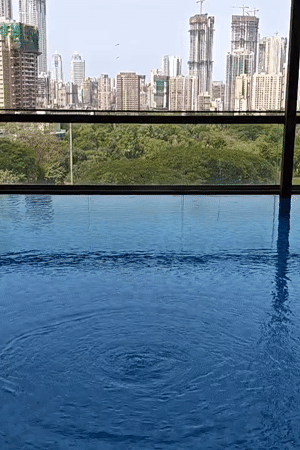 Indoor pool with city view captured in Mumbai