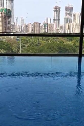 Indoor pool with city view captured in Mumbai
