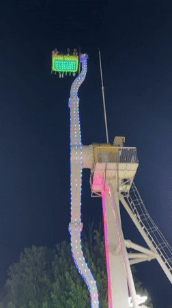 Evening crowds enjoy illuminated amusement park in Khujand, Tajikistan