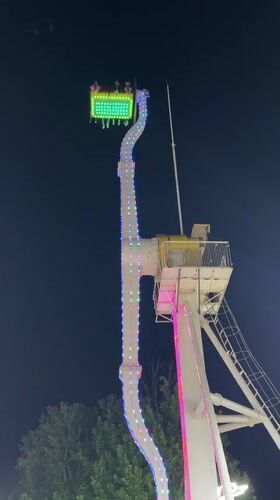 Evening crowds enjoy illuminated amusement park in Khujand, Tajikistan