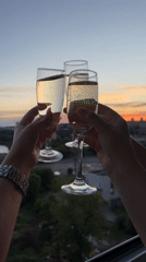 Women celebrate with champagne toast at sunset in Izhevsk