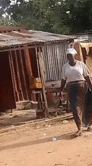Foot traffic and a mobile vendor along a dusty community path.