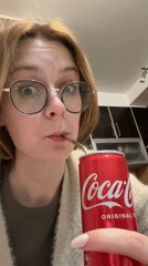 Person drinks Coca-Cola with metal straw in Kragujevac
