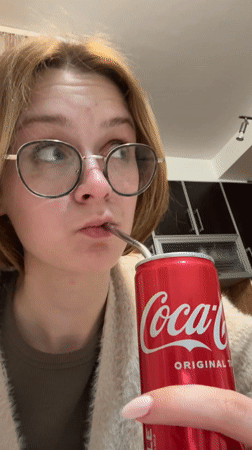 Person drinks Coca-Cola with metal straw in Kragujevac