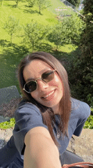 Woman takes selfie on sunny afternoon in Bergamo