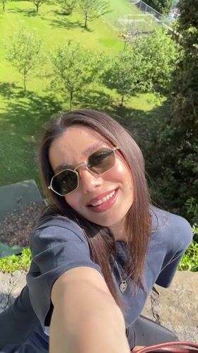 Woman takes selfie on sunny afternoon in Bergamo