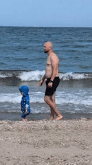 Breezy beach afternoon: wind, wading, and a foraging pigeon