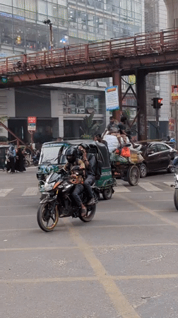 Early morning street life documented across Dhaka intersections
