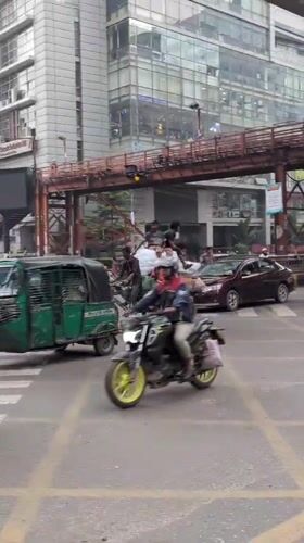 Early morning street life documented across Dhaka intersections