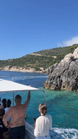 Boating past sea caves and cliffs off Zakynthos coast