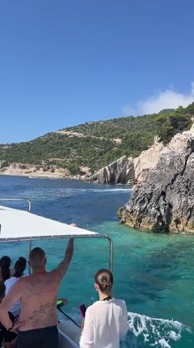 Boating past sea caves and cliffs off Zakynthos coast