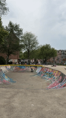 Colorful concrete skate bowl at an Amsterdam skatepark