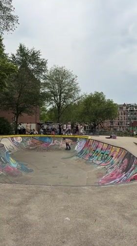 Colorful concrete skate bowl at an Amsterdam skatepark