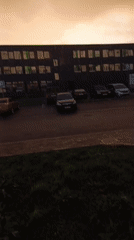Stormy golden sunset over a Bugry parking lot