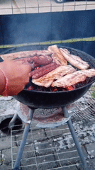 Outdoor charcoal grilling session features sausages and pork belly