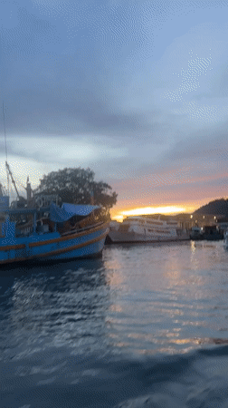 Ratsada harbor at dusk, boats moored as the sun sets