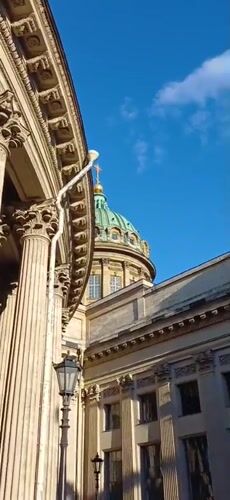 Sunny afternoon at Kazan Cathedral with a street violinist performing outside.