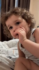 Child enjoys TV and books during quiet evening in Tobolsk