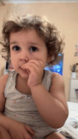 Child enjoys TV and books during quiet evening in Tobolsk