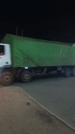 Night traffic activity with trucks and police in Bukuru