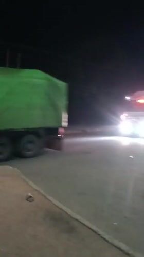 Night traffic activity with trucks and police in Bukuru