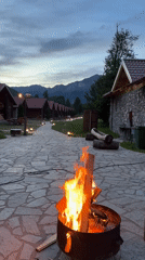 Evening campfire gathering at Montenegro eco-lodge with music and dining
