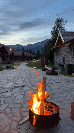 Evening campfire gathering at Montenegro eco-lodge with music and dining