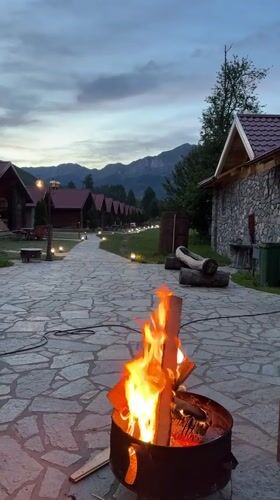 Evening campfire gathering at Montenegro eco-lodge with music and dining