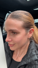 Young woman sings along to music in car in Tbilisi