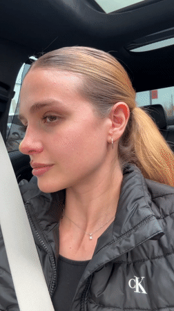 Young woman sings along to music in car in Tbilisi