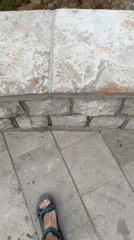 Stone steps lead to a sweeping view of Sveti Stefan's islet