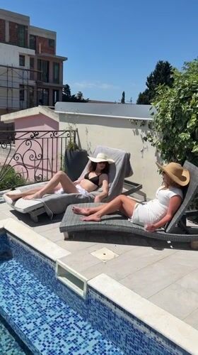 Women enjoy poolside Sunday morning in Montenegro coastal town