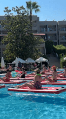 Paddleboard yoga class in a sunny Manavgat resort pool