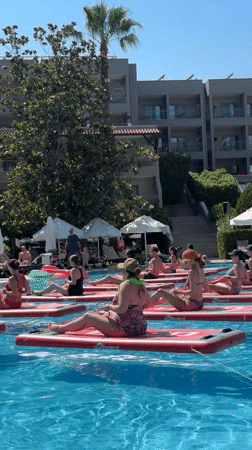 Paddleboard yoga class in a sunny Manavgat resort pool