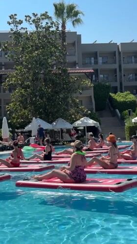 Paddleboard yoga class in a sunny Manavgat resort pool