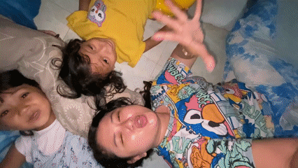 Family spends morning together drawing and taking photos indoors