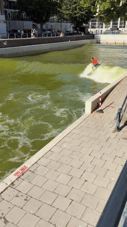 Urban surfer rides artificial river wave in Rotterdam