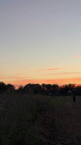 Sunset over rural Chervonosilske, warm sky, quiet fields