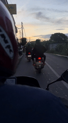 Motorcycle ride through Kuta Selatan at dusk captured