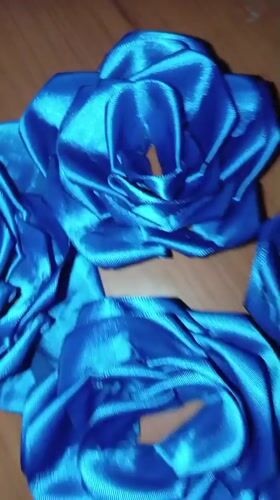 Blue satin roses documented on wooden surface in Venezuela