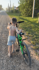 Boy with green bike spotted on rural road in Al'nyash