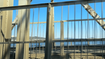 Vehicle crosses metal truss bridge in Ust-Ilimsk, Russia