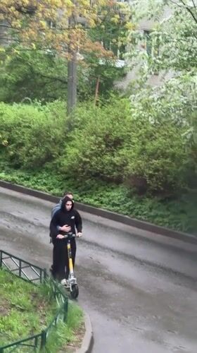 Two people share electric scooter ride in Staraya, Russia