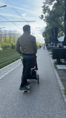 Man skateboards while pushing baby stroller in Luxembourg