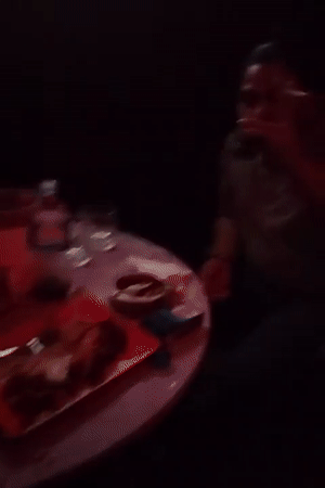 Person drinks and smokes at Dhaka bar establishment