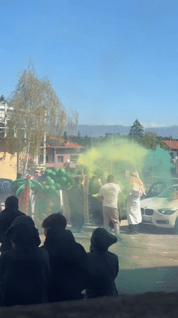 Cultural celebration with traditional dress, smoke displays in Velingrad