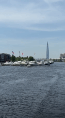 White yachts docked in Saint Petersburg harbor beneath city skyline