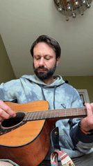 Man plays acoustic guitar in Moscow morning session
