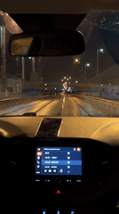 Night driving through wet streets in Chaikovsky, Russia