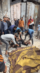Casualties documented on Gaza street amid damaged urban environment